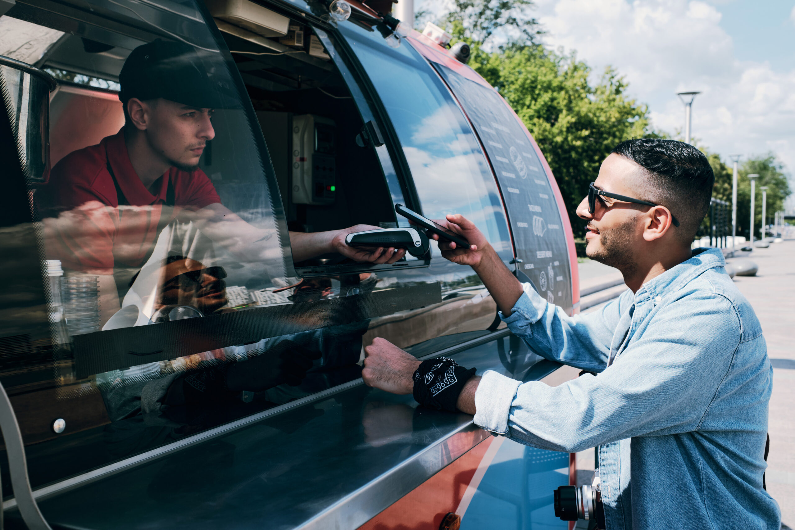 Food Truck Collecting Payment From Two Customers